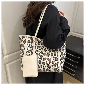 Detail of large leopard print tote bag set with matching off-white small zipper pouch