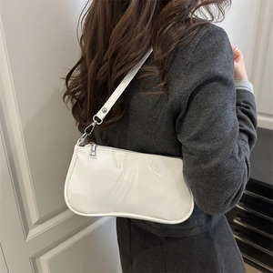 Minimalist white patent leather baguette bag for women with silver hardware and shoulder strap