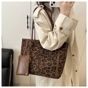 Detail view of large leopard print tote bag with small matching brown accessory pouch