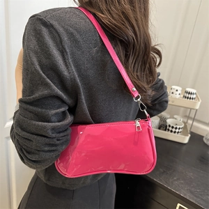 Glossy magenta patent leather baguette bag with silver hardware for casual chic style