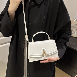 Chic white leather square handbag with golden V-clasp and adjustable shoulder strap