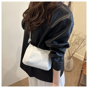 Chic white leather crossbody bag shown on a model for size and style perspective
