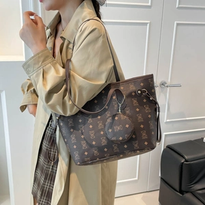 Retro brown oversized tote bag with bear pattern and matching round charm worn on shoulder