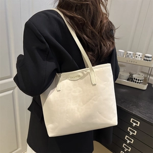 Retro cream white large capacity tote bag with fashion label shown on shoulder model