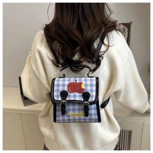 Back view of a blue gingham mini backpack featuring fruit prints and thin black straps