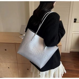 Détail du sac cabas argent mat avec inscription TOTE BAG embossée sur cuir PU