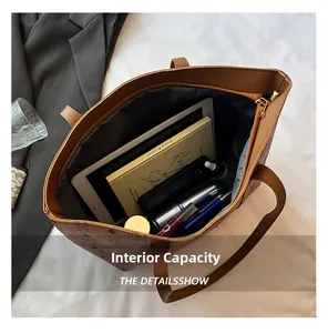 Macro detail of the spacious brown leather tote bag interior with vintage monogram pattern