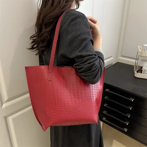 Minimalist red crocodile embossed tote bag for women shown as a stylish shoulder bag