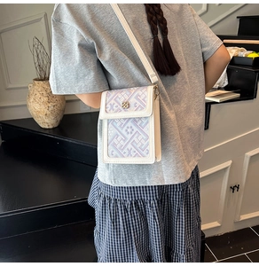 Detail of New Chinese style embroidered phone bag with golden floral metal buckle