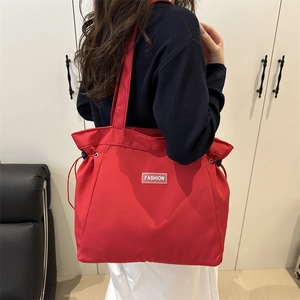 Chic red nylon tote bag with fashion tag and side drawstrings for women's daily commute