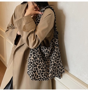 Detail of fashion leopard print tote bag showing the side label and canvas texture