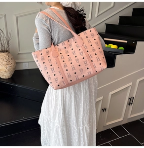 Macro detail of the pink tote bag featuring a teddy bear print and premium leather texture