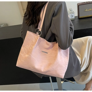 Detail showing pink textured PU leather tote bag with silver metal ring handle attachment