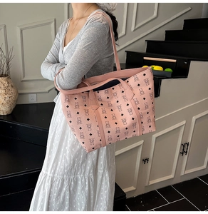 Pink large tote bag with cartoon bear print shown on shoulder for daily fashion style