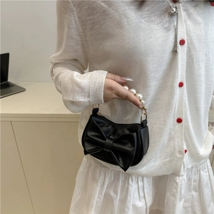 Minimalist black mini handbag with large bow and white pearl handle for women