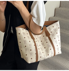 Lifestyle shot of large capacity tote bag with bear print and brown leather handles