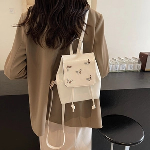 White mini PU leather backpack with 3D butterfly accents and drawstring closure