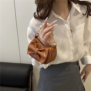 Caramel brown small square bag with large bow and elegant pearl handle strap