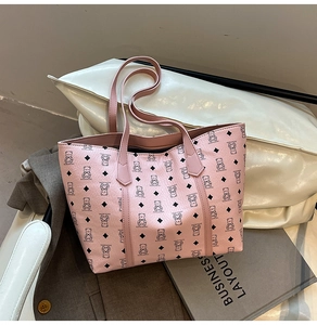 Close-up of pink tote bag featuring cartoon bear print and lychee textured PU leather