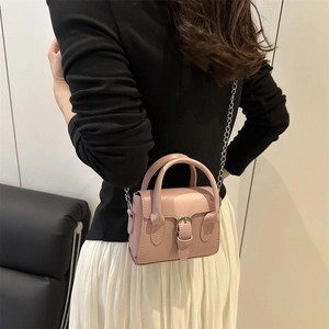 Pink minimalist crossbody bag with metal chain strap and leather buckle detail for women