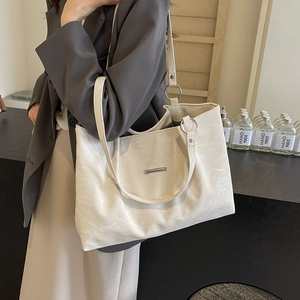 Minimalist creamy white large tote bag in textured faux leather with silver hardware