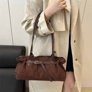 Retro dark brown suede tote bag with leather strap shown on model in trench coat