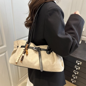 Retro beige suede tote bag with wooden bead tassels and black leather strap details
