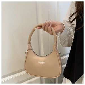 Detail of a beige leather crescent bag featuring minimalist Fashion & Bags text