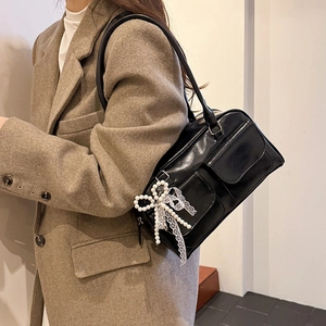 Classic black PU leather Boston shoulder bag with pearl lace bow charm on model
