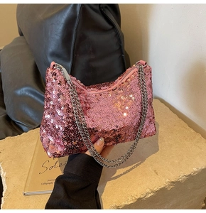 Close-up of pink sequined shoulder bag with metallic chain and party-style finish