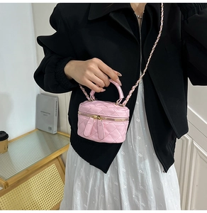 Detail of pink quilted leather mini vanity bag with gold-tone metal chain strap