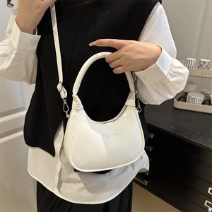 Minimalist white semi-circle crescent bag with top handle and adjustable shoulder strap