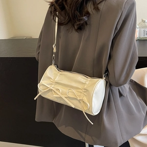 Chic off-white pleated cylinder pillow bag with leather bows and slim shoulder strap