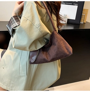 Close-up of deep brown suede handbag showing high-quality texture and retro geometry