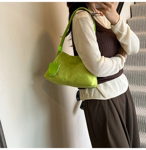 Lime green hobo bag featuring knot shoulder strap detail and small hanging pouch accessory