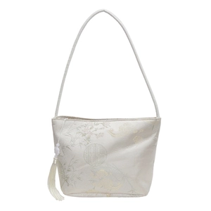 Minimalist beige jacquard bucket bag with traditional floral patterns and white tassels