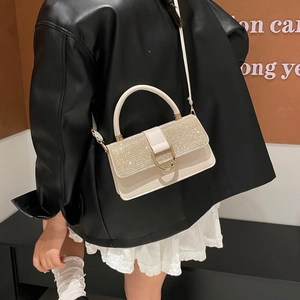 Minimalist square crossbody bag with rhinestone flap and gold buckle on a model