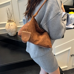 Chic brown suede hobo underarm bag with minimalist knot strap and side pendant