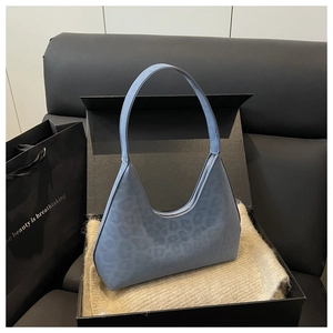 Close-up of light blue leopard embossed hobo bag inside a black premium gift box