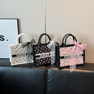 Three elegant bow-textured tote bags in white, black, and pink with lace ribbon details