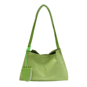 Minimalist grass green faux suede underarm bag with decorative matching coin pouch