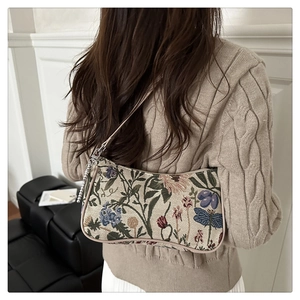 Close-up of vintage floral jacquard underarm bag with dragonfly patterns and chain strap
