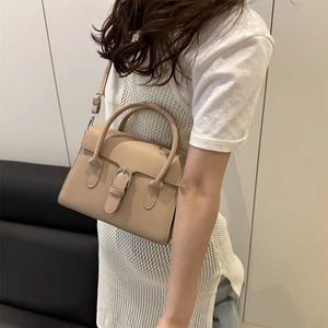 Minimalist beige crossbody bag with silver buckle flap and top handle for women
