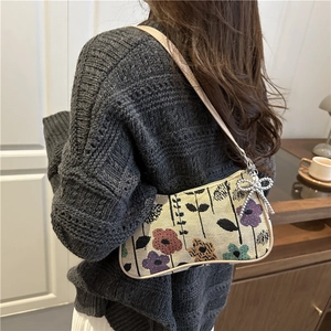Floral tapestry underarm bag with a silver butterfly charm and brown leather strap