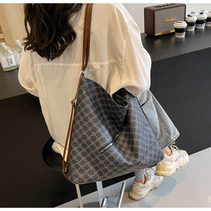 Detail of large tote bag showing retro patterned fabric and premium leather shoulder strap