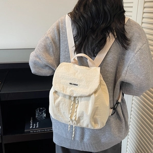 Chic beige nylon backpack for women with a spacious design and adjustable fabric straps