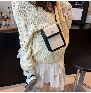 Minimalist canvas crossbody bag with gold clover lock styled with a casual autumn outfit