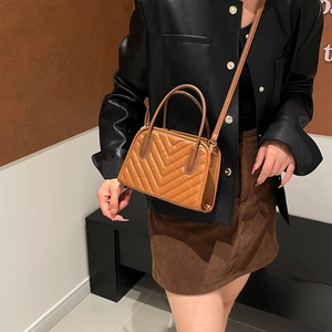 Brown quilted mini crossbody bag for women with dual handles and V-stitch texture