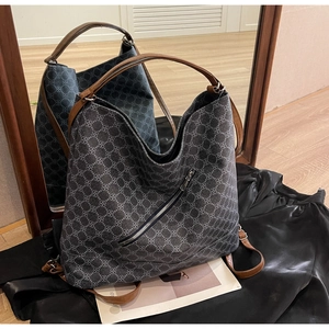Close-up of geometric pattern on tote bag with leather strap and zipper detail