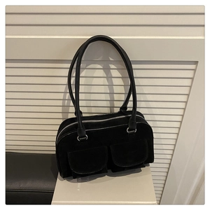 Detail of black matte suede shoulder bag with dual large flap pockets and silver hardware